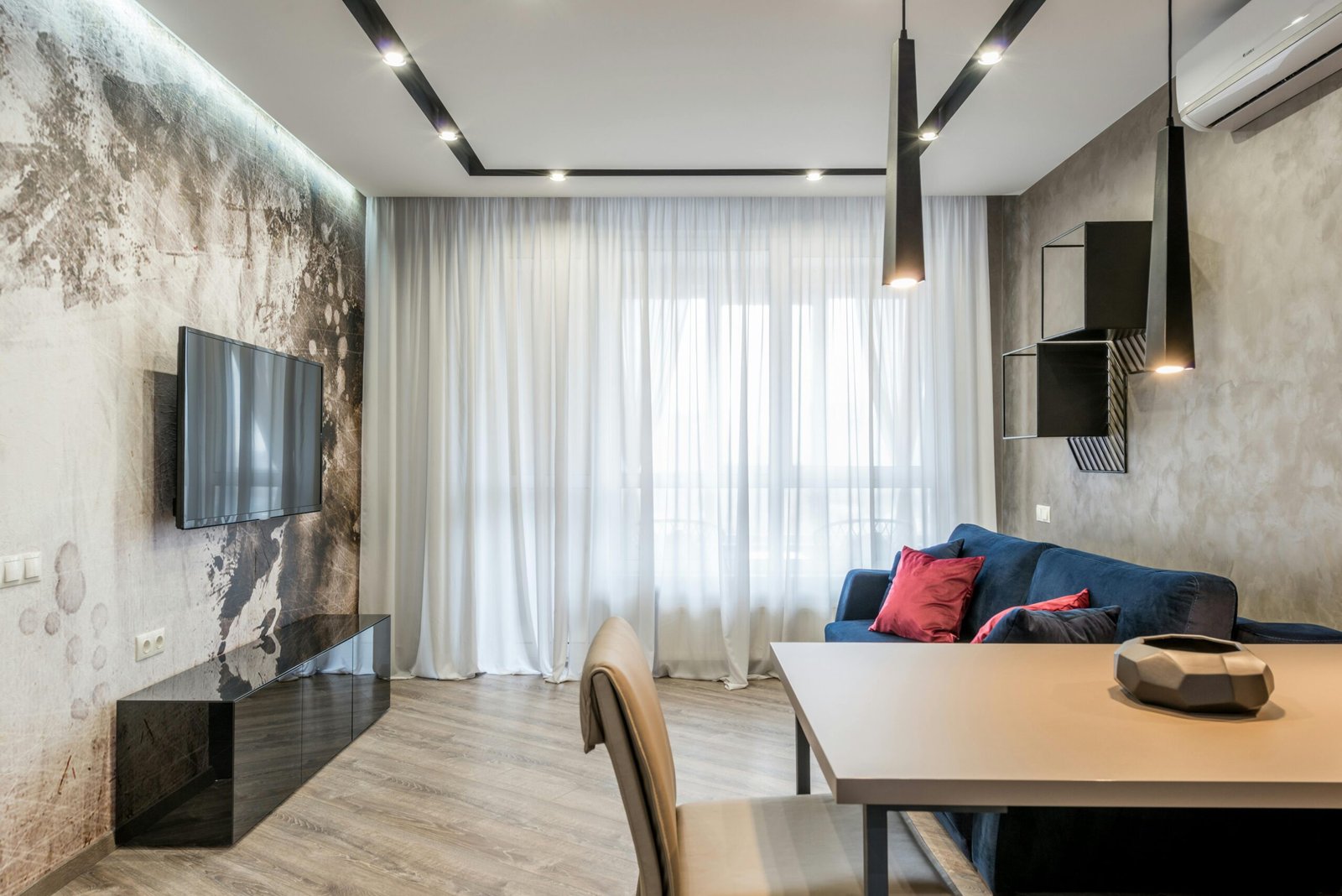Stylish modern living room with minimalist decor, featuring a sleek sofa and elegant lighting.